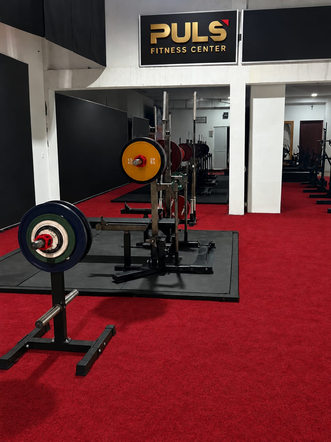 PULS gym power rack and loaded barbell